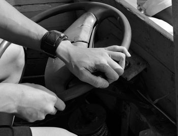 Midsection of man holding steering wheel