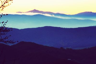 Scenic view of silhouette mountains against sky at sunset