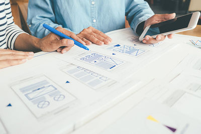Low section of people working on table