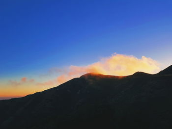 Scenic view of silhouette mountains against sky during sunset