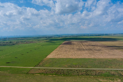 Scenic view of farm against sky