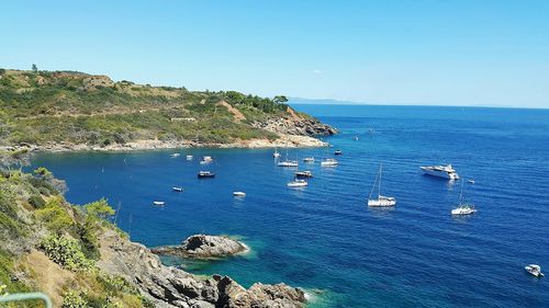 High angle view of sea against clear blue sky