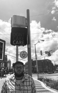 Man on road against sky in city