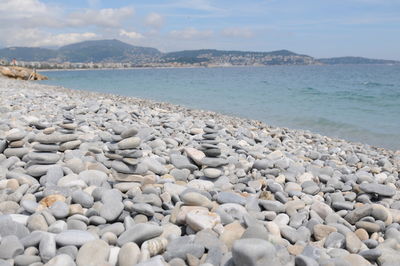 Rocks on beach against sky