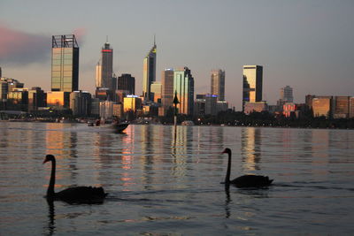 View of city at waterfront during sunset