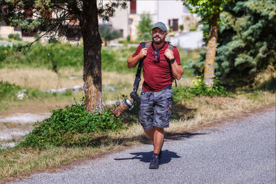 Mountain hiker photographer explores the area for the photographic hunting of wild animals. 