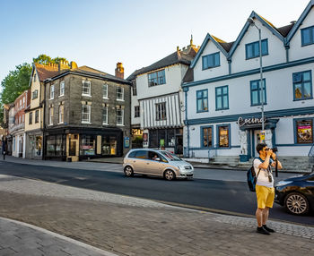 Cars on street against buildings in city