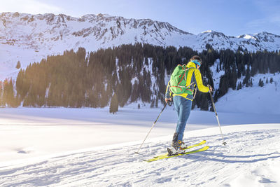 Person skiing on snowcapped mountain during winter