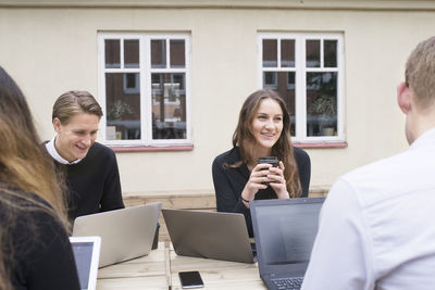 Business people using laptops