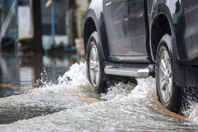 Pick-up truck on a flooded street.