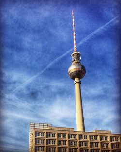 Low angle view of communications tower against sky