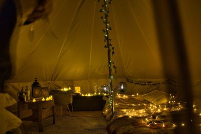 Illuminated christmas lights on table at night