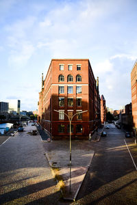 View of city street and buildings against sky