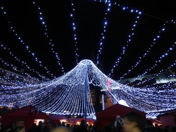 Low angle view of illuminated ferris wheel at night