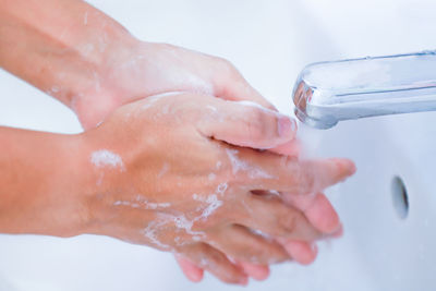 Midsection of man with water drops