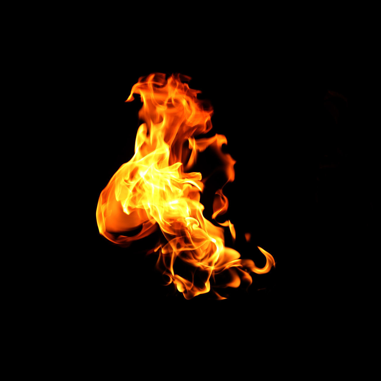 CLOSE-UP OF FIRE BURNING AGAINST BLACK BACKGROUND