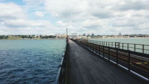 View of bridge over river against cloudy sky