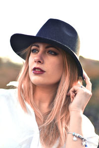 Portrait of beautiful young woman wearing hat