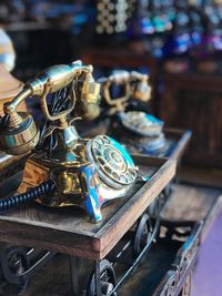 Close-up of old rotary phones on table at antique shop