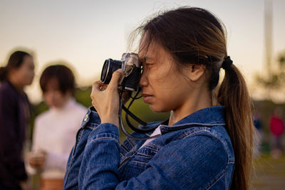 Portrait of woman photographing