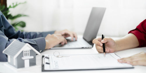 Midsection of business colleagues working at office