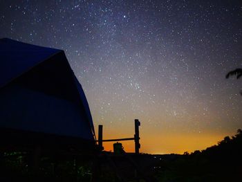 Low angle view of silhouette building against sky at night