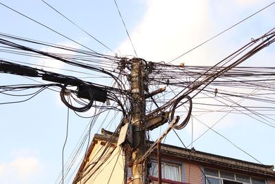 Low angle view of electricity pylon against sky