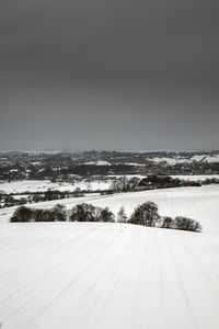 Scenic view of landscape against clear sky during winter