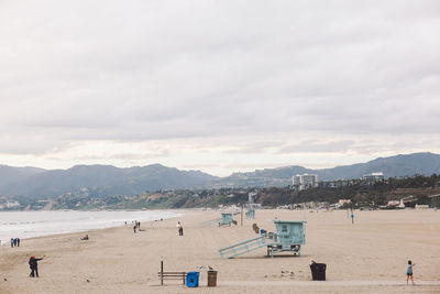 People on beach against sky