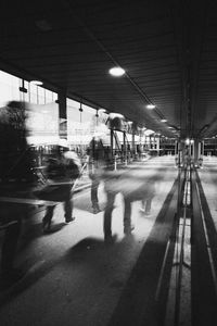 Blurred motion of people waiting at railroad station