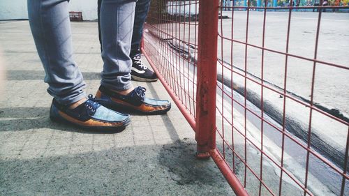 Low section of woman standing on tiled floor