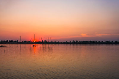 Scenic view of sea against orange sky