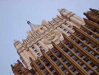 Low angle view of buildings in city against clear sky