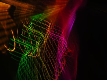 Multi colored light painting against black background