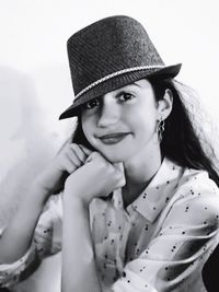 Portrait of smiling young woman wearing hat