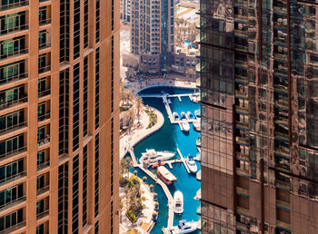 High angle view of harbor seen through buildings in city