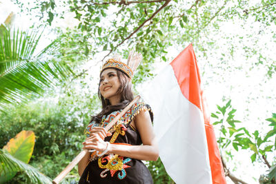 Portrait of young woman holding umbrella