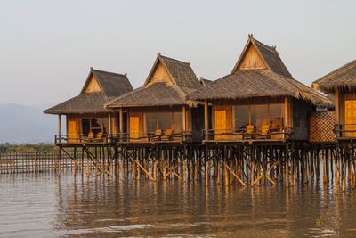 Gazebo in lake against clear sky