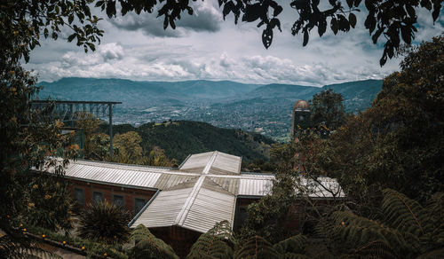 High angle view of building and mountains against sky