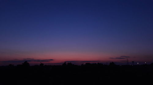 Scenic view of silhouette landscape against clear sky at sunset