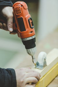 Close-up of man installing wheels in wood