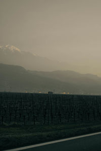 Scenic view of field and mountains against sky