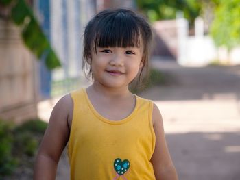 Portrait of smiling girl standing outdoors