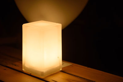 Close-up of illuminated lamp against black background