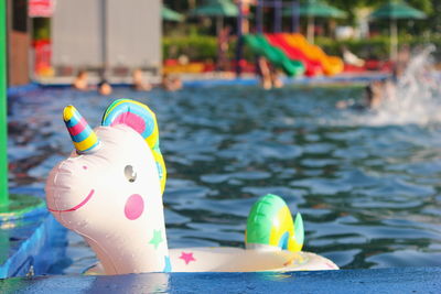 Close-up of toys floating in swimming pool