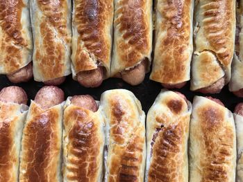 High angle view of sausage rolls on baking sheet