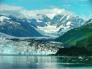 Scenic view of lake and mountains against sky