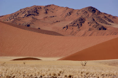 Sand dune in desert against sky