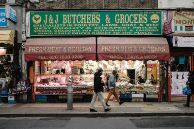 Full length of people standing on street in city