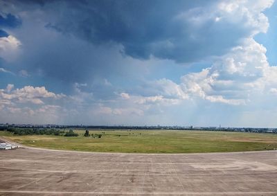 Scenic view of airport runway against sky